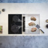 BORA_Professional_Rough_PKAS3FITR_Topshot BORA Professional 3.0 downdraft hob with integrated cooktop extractor and sleek black glass surface