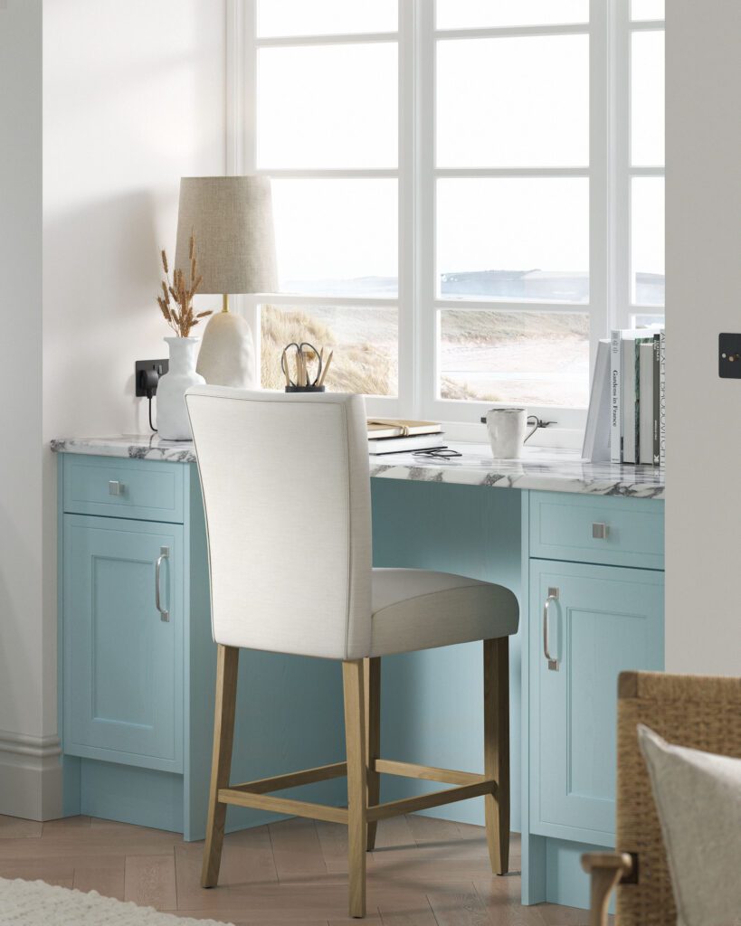 Bespoke pantry blue home office and study with fitted shaker cabinetry, integrated desk, marble-effect worktop and window-side workspace.