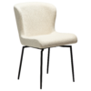 The glam swivel chair in simply beige boucle with black legs.