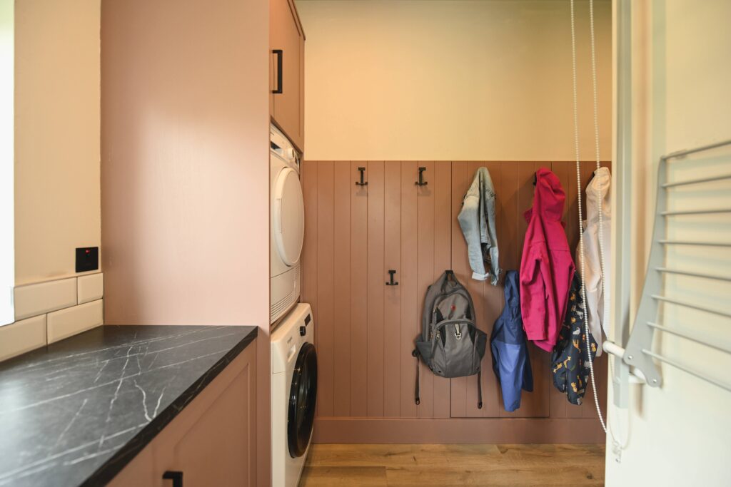A well-designed utility space should work hard and look good doing it. This pink boot room blends function and style with clever storage and a bold colour choice.