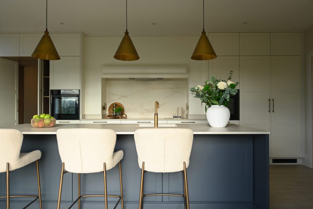 Kitchen island with seating in a shaker style kitchen designed for a family home in Tipperary