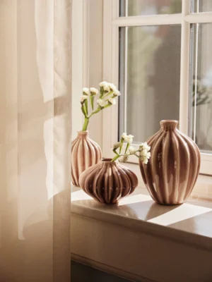 A set of 3 Amalie Vase in fawn colour on a window cill.