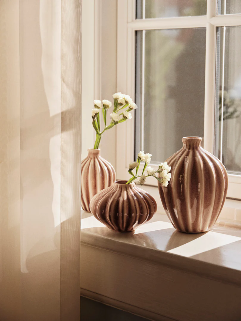 A set of 3 Amalie Vase in fawn colour on a window cill.