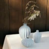 A set of 3 amalie vase in light blue on a table