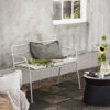Eden bench in beige grey outside in a pation wityh a cushion