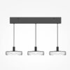 Float triple pendant light with clear glass shades and black frame over kitchen island