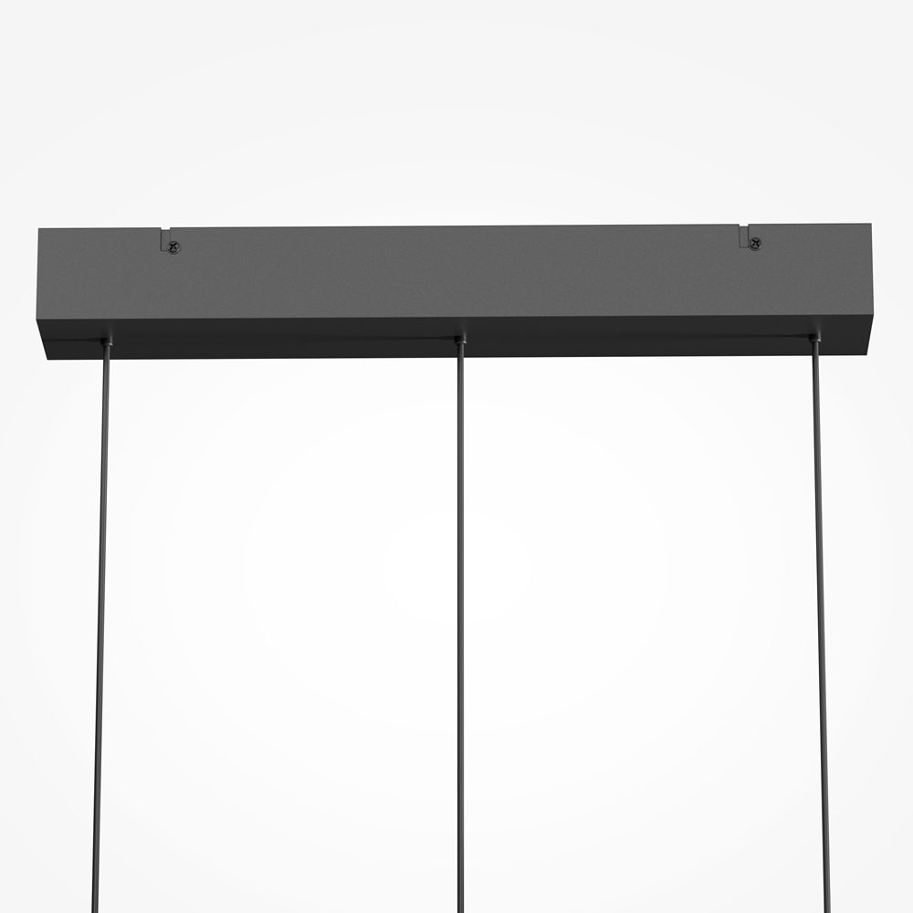 Float triple pendant light with clear glass shades and black frame over kitchen island