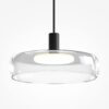 Float triple pendant light with clear glass shades and black frame over kitchen island