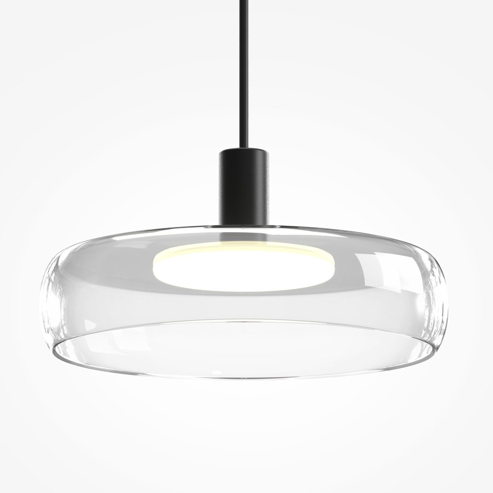 Float triple pendant light with clear glass shades and black frame over kitchen island