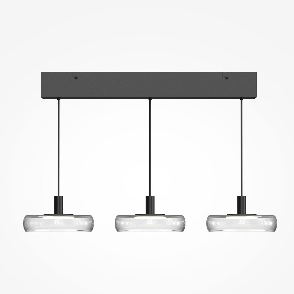 Float triple pendant light with clear glass shades and black frame over kitchen island