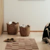 A set of 2 Lola baskets used in a bedroom for storage