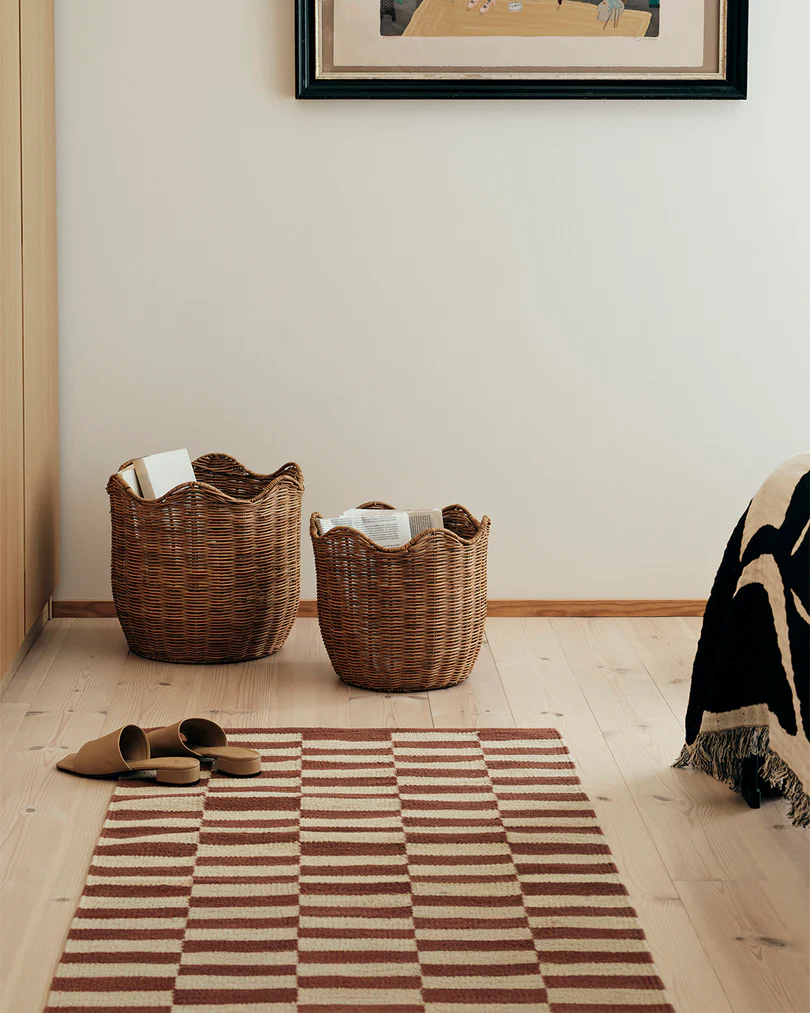 A set of 2 Lola baskets used in a bedroom for storage