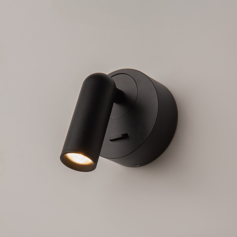 black adjustable wall reading light with focused spotlight, modern bedside wall light