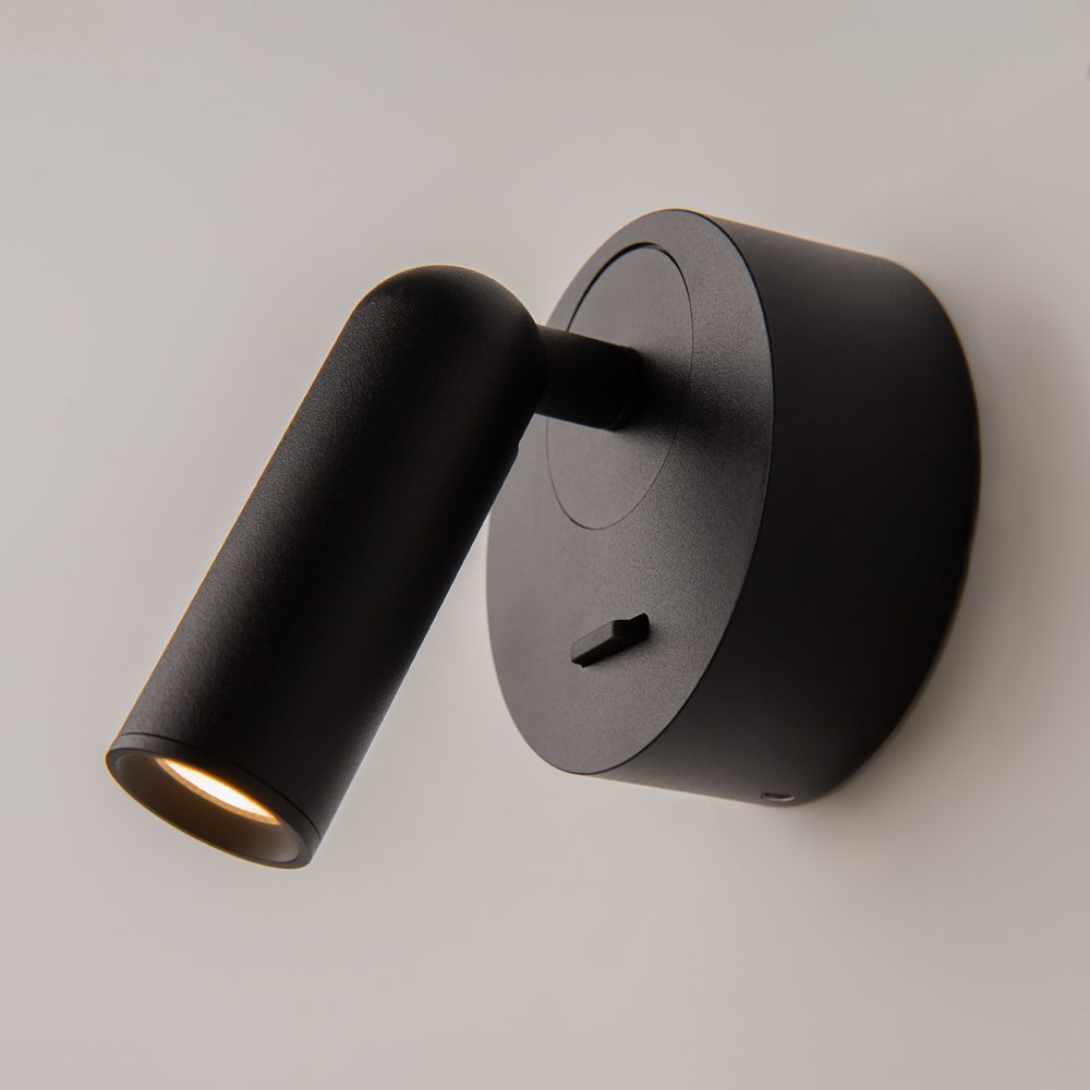 black adjustable wall reading light with focused spotlight, modern bedside wall light