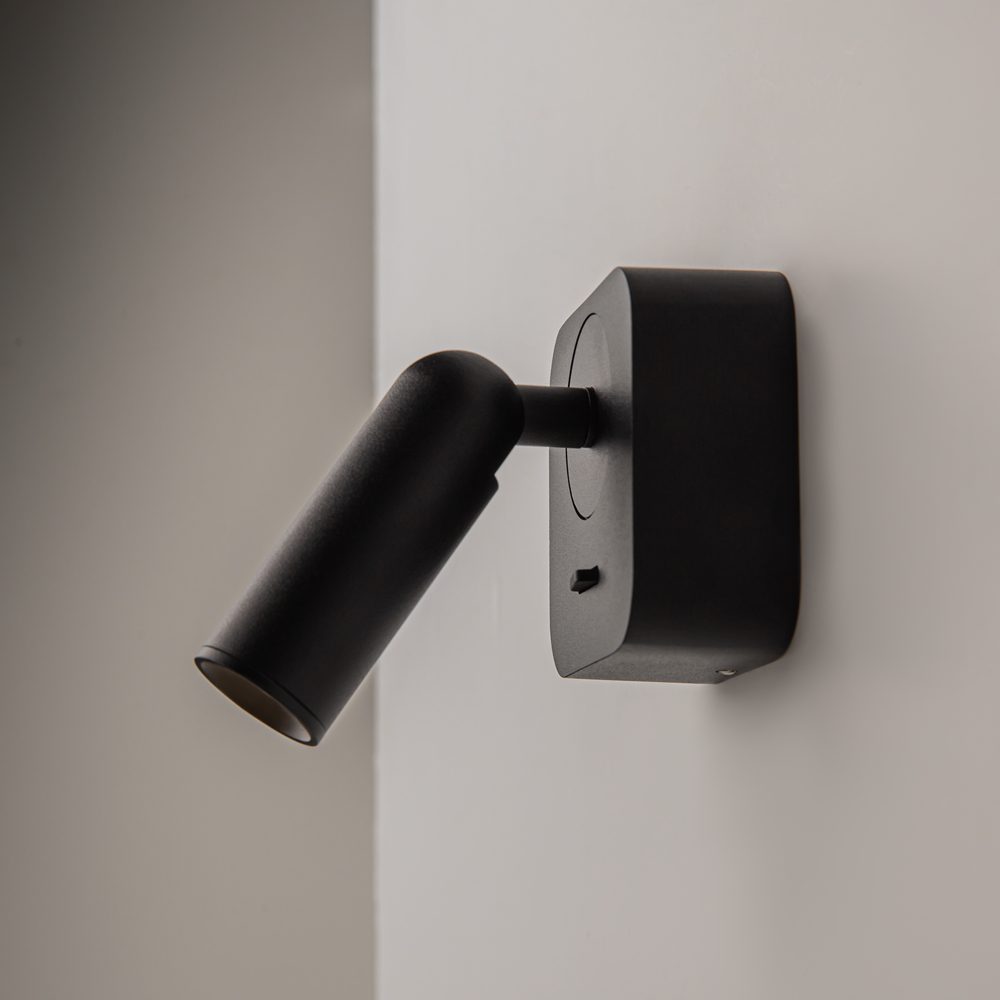 black adjustable wall reading light with focused spotlight, modern bedside wall light