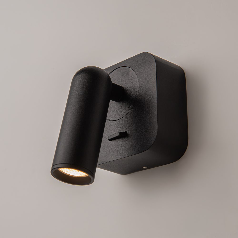 black adjustable wall reading light with focused spotlight, modern bedside wall light