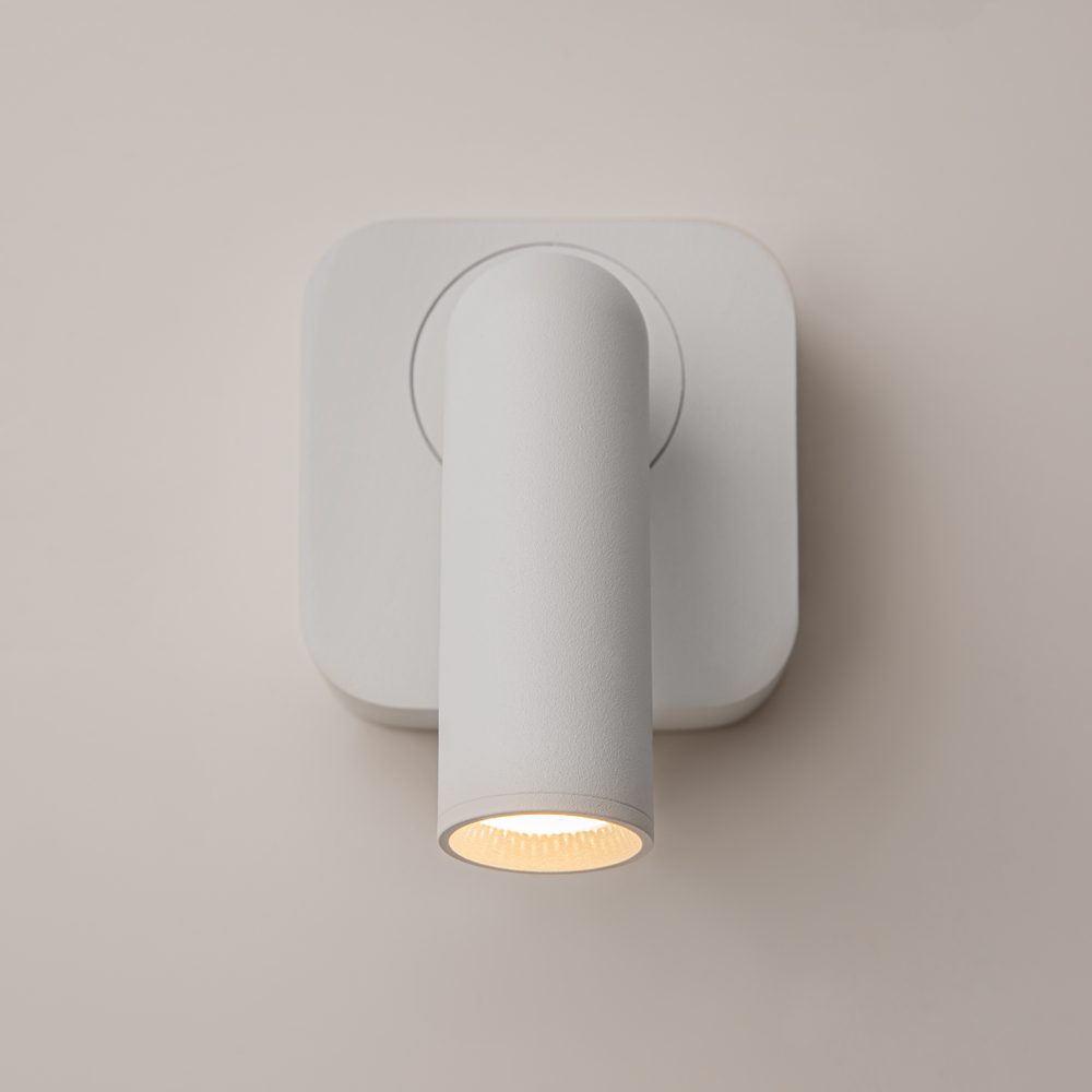 white adjustable wall reading light with focused spotlight, modern bedside wall light