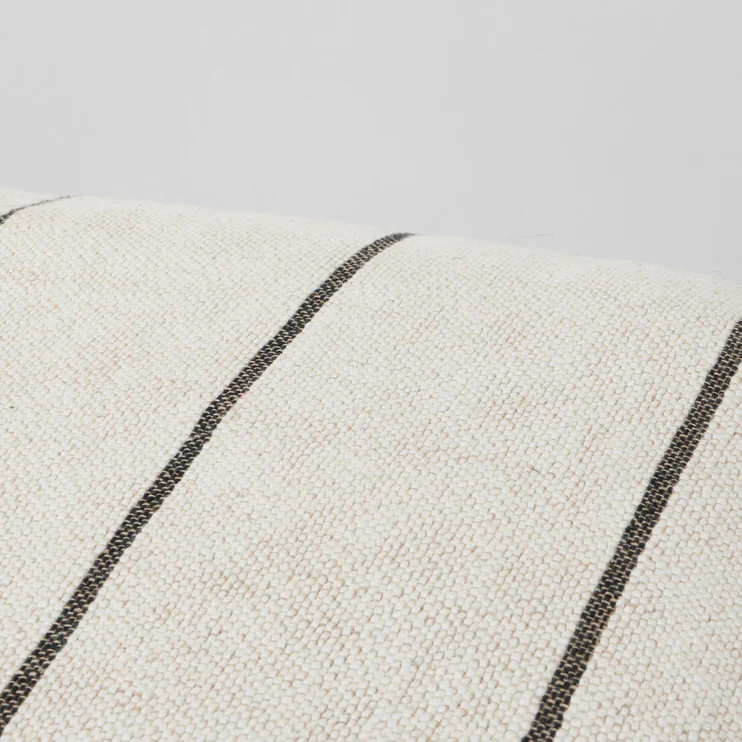 close up of beige and black striped cotton linen fabric pouf texture