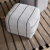 beige pouf used as a footstool