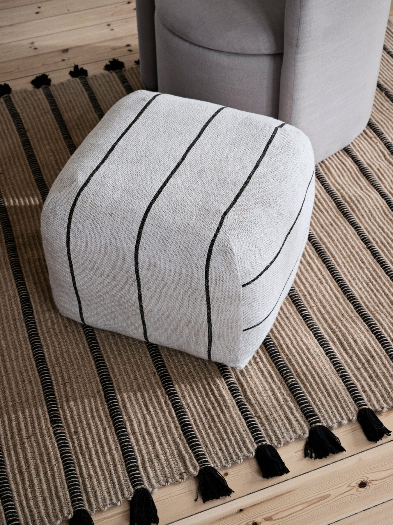beige pouf used as a footstool