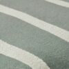 close up of green and beige striped cotton linen fabric pouf texture