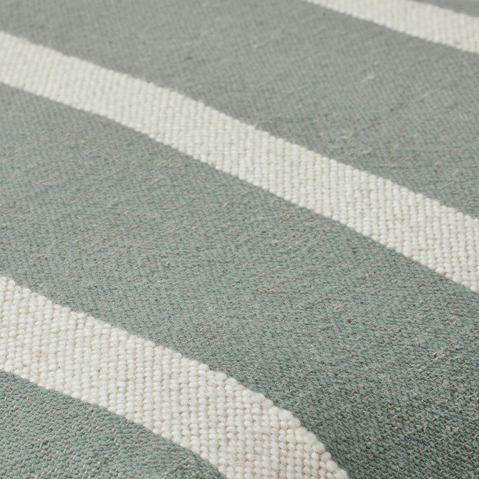 close up of green and beige striped cotton linen fabric pouf texture