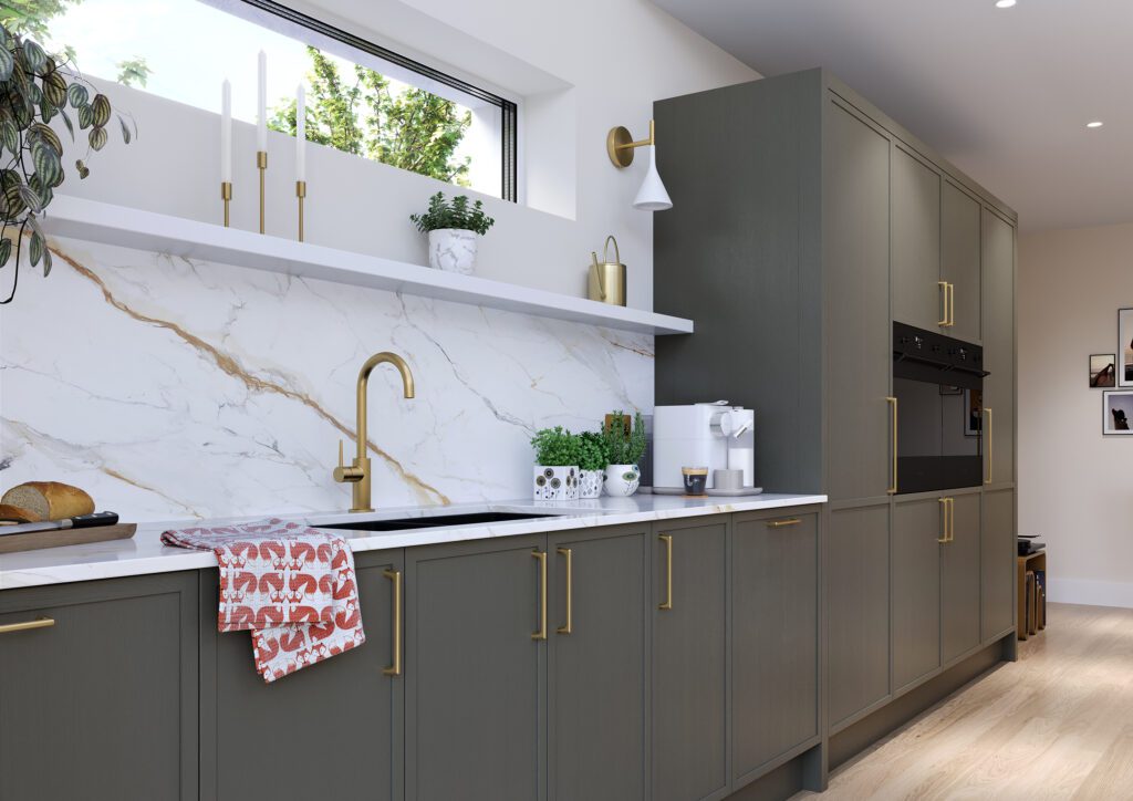 Warm grey shaker kitchen with stone splashback and brass tap in a bright modern Irish home