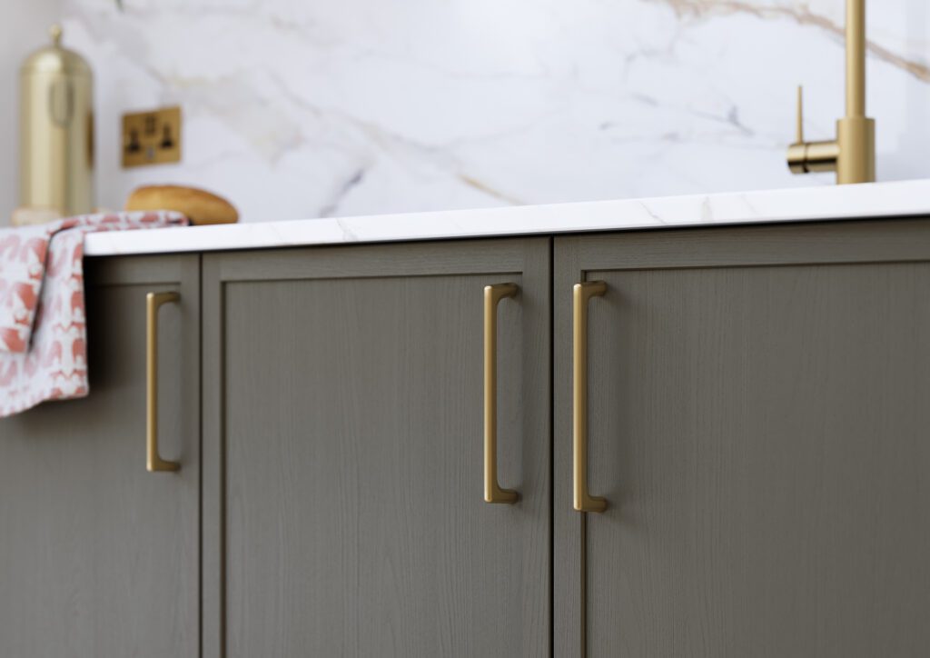 Close up of graphite shaker kitchen cabinetry with textured glass and modern handles