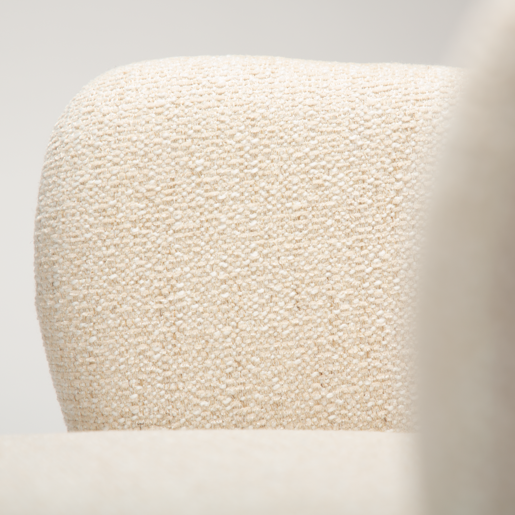 close up of the simple beige boucle fabric on the Bae chair