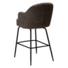 Rear angle of the Bae swivel counter stool in major brown boucle fabric with black swivel legs.