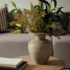 Florentina beige vasewith plants on a coffee table