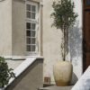 The Ray Beige Floor Vase outdoors