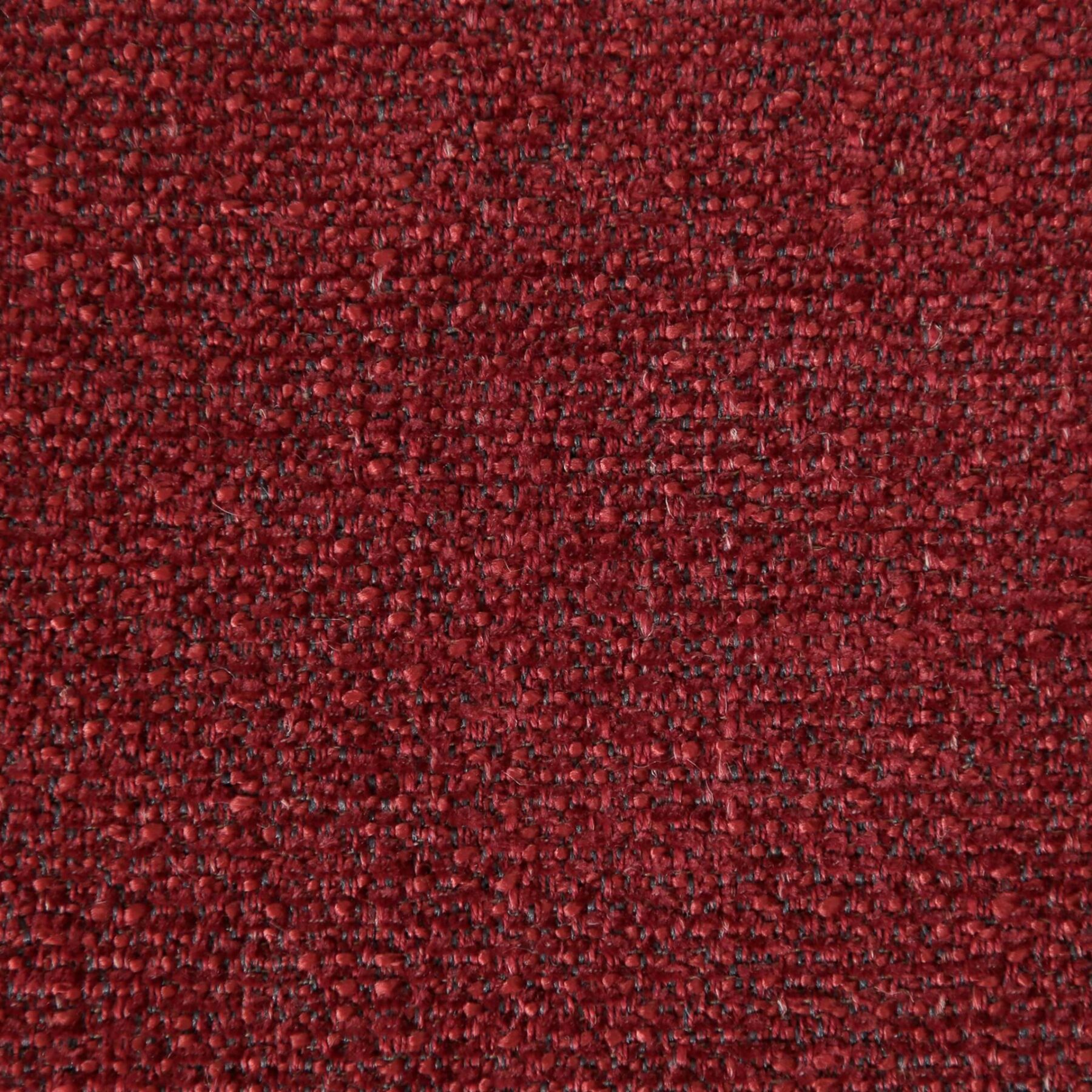 DUBNA lounge chair upholstered in Merlot fabric with a sculptural curved design for modern living rooms and lounge spaces.