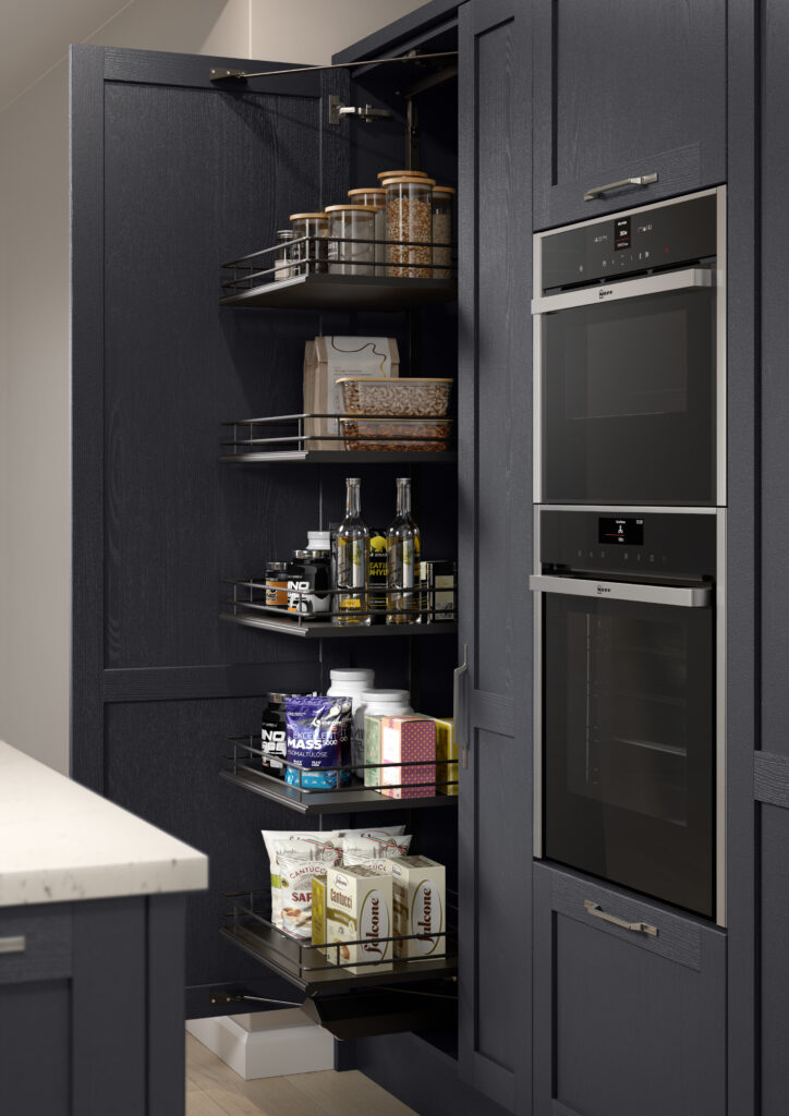 Tall pull-out pantry storage unit in a navy shaker kitchen.