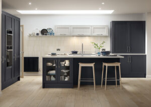 Navy shaker kitchen with large island, tall storage cabinets and light grey wall units.
