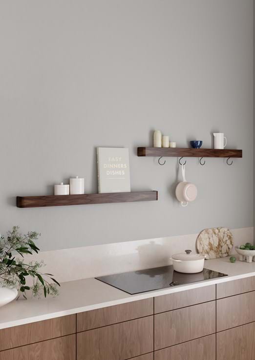 Protopia wall shelf in walnut veneer with a slim profile and curved ends, ideal for displaying artwork, books, photographs, and decorative accessories.