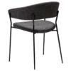 reboot-armchair-raven-black-angle Reboot armchair upholstered in Raven Black fabric with a modern curved silhouette and upholstered frame.
