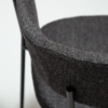 reboot-armchair-raven-black-close Reboot armchair upholstered in Raven Black fabric with a modern curved silhouette and upholstered frame.