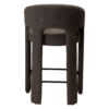 Splendor counter stool upholstered in major brown bouclé fabric with a curved backrest, padded seat and integrated black footrest, ideal for kitchen islands and breakfast bars.