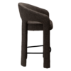 Splendor counter stool upholstered in major brown bouclé fabric with a curved backrest, padded seat and integrated black footrest, ideal for kitchen islands and breakfast bars.