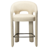 Splendor counter stool upholstered in simply beige fabric with a curved backrest, padded seat and integrated black footrest, ideal for kitchen islands and breakfast bars.