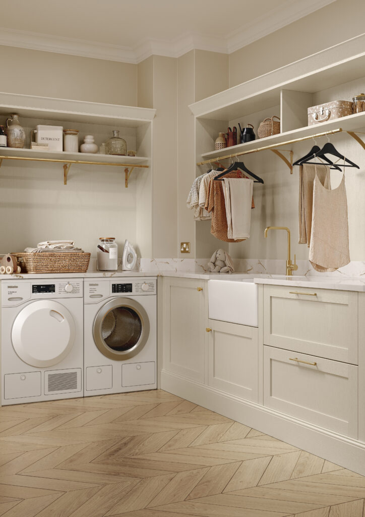 Bespoke utility room with taupe shaker cabinetry, Belfast sink and brass rail storage.