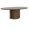 Walnut oak oval dining table with a warm wood finish, rounded tabletop, and sculptural pedestal base on a white background.
