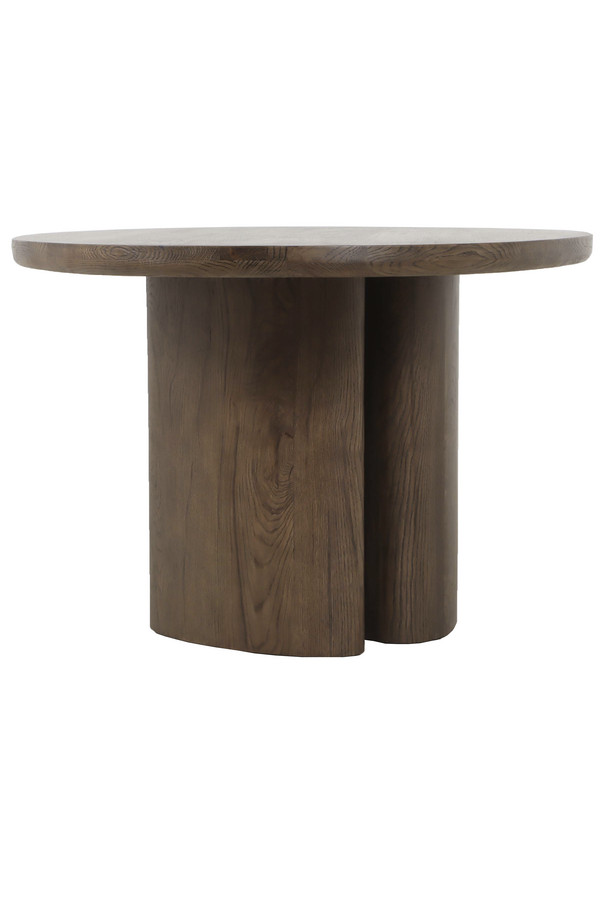 Walnut oak oval dining table with a warm wood finish, rounded tabletop, and sculptural pedestal base on a white background.