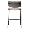 ZED counter stool upholstered in Cashmere bouclé fabric with slim black metal legs and integrated armrests, designed for modern kitchen islands and breakfast bars.