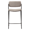 ZED counter stool upholstered in Cashmere bouclé fabric with slim black metal legs and integrated armrests, designed for modern kitchen islands and breakfast bars.