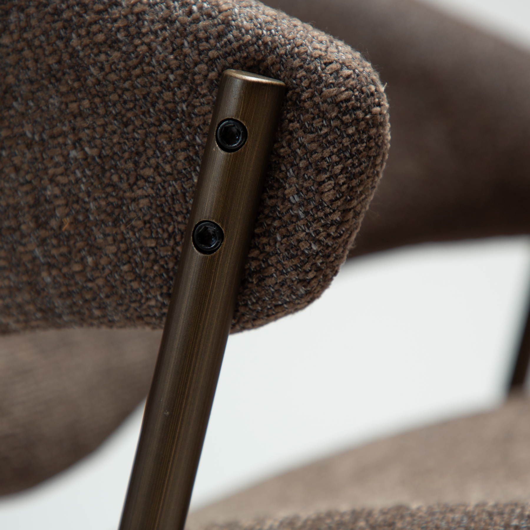 zone-dining-chair-major-brown-boucle-antique-brass-legs-zoom ZONE dining chair upholstered in Major Brown bouclé fabric with antique brass legs, featuring a curved Scandinavian-inspired backrest for modern dining spaces.
