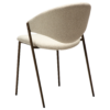 zone-dining-chair-simply-beige-boucle-antique-brass-legs-angle ZONE dining chair upholstered in Simply Beige bouclé fabric with antique brass legs, featuring a curved Scandinavian-inspired backrest for modern dining spaces.