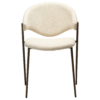 zone-dining-chair-simply-beige-boucle-antique-brass-legs-front ZONE dining chair upholstered in Simply Beige bouclé fabric with antique brass legs, featuring a curved Scandinavian-inspired backrest for modern dining spaces.