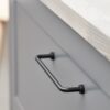 Lounge matt black Zamac cabinet handle with ergonomic concave grip for kitchen cabinets and bespoke furniture.